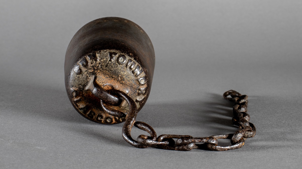 A metal drinking cup on a chain for attaching to a drinking fountain