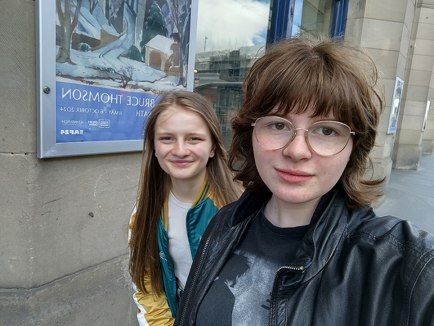 Two young people take a selfie outside the City Art Centre building