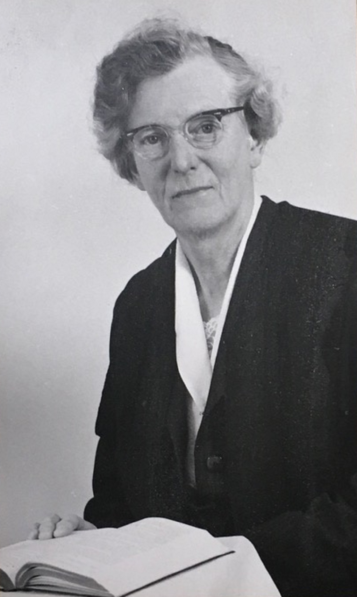 Photograph of Kate Brotherston seated with a book