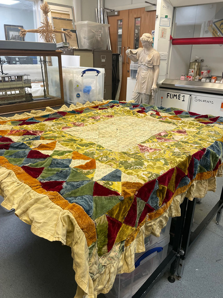 Patchwork quilt displayed on a table