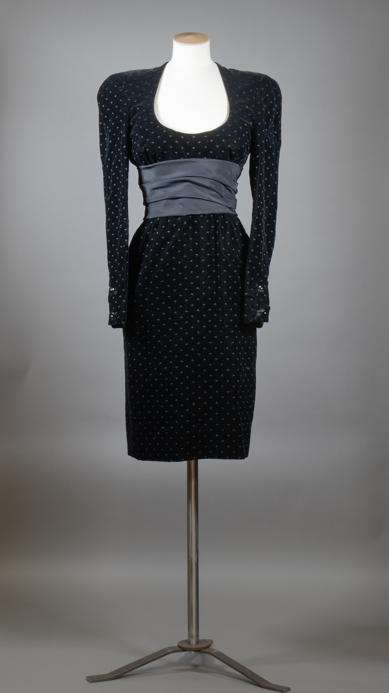 A black velvet cocktail dress mounted on a mannequin