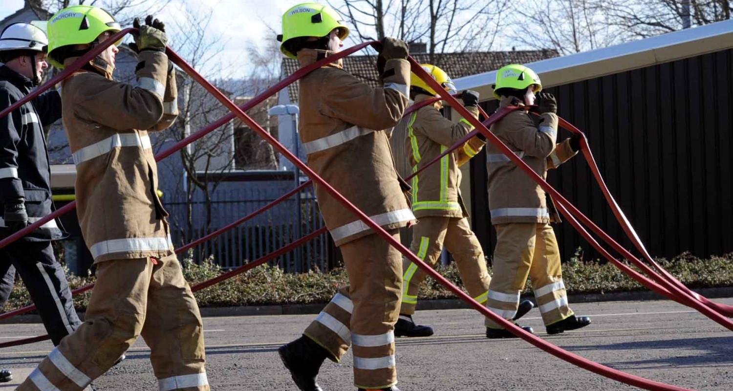 Firefighters in Gullane participating in hose running drills