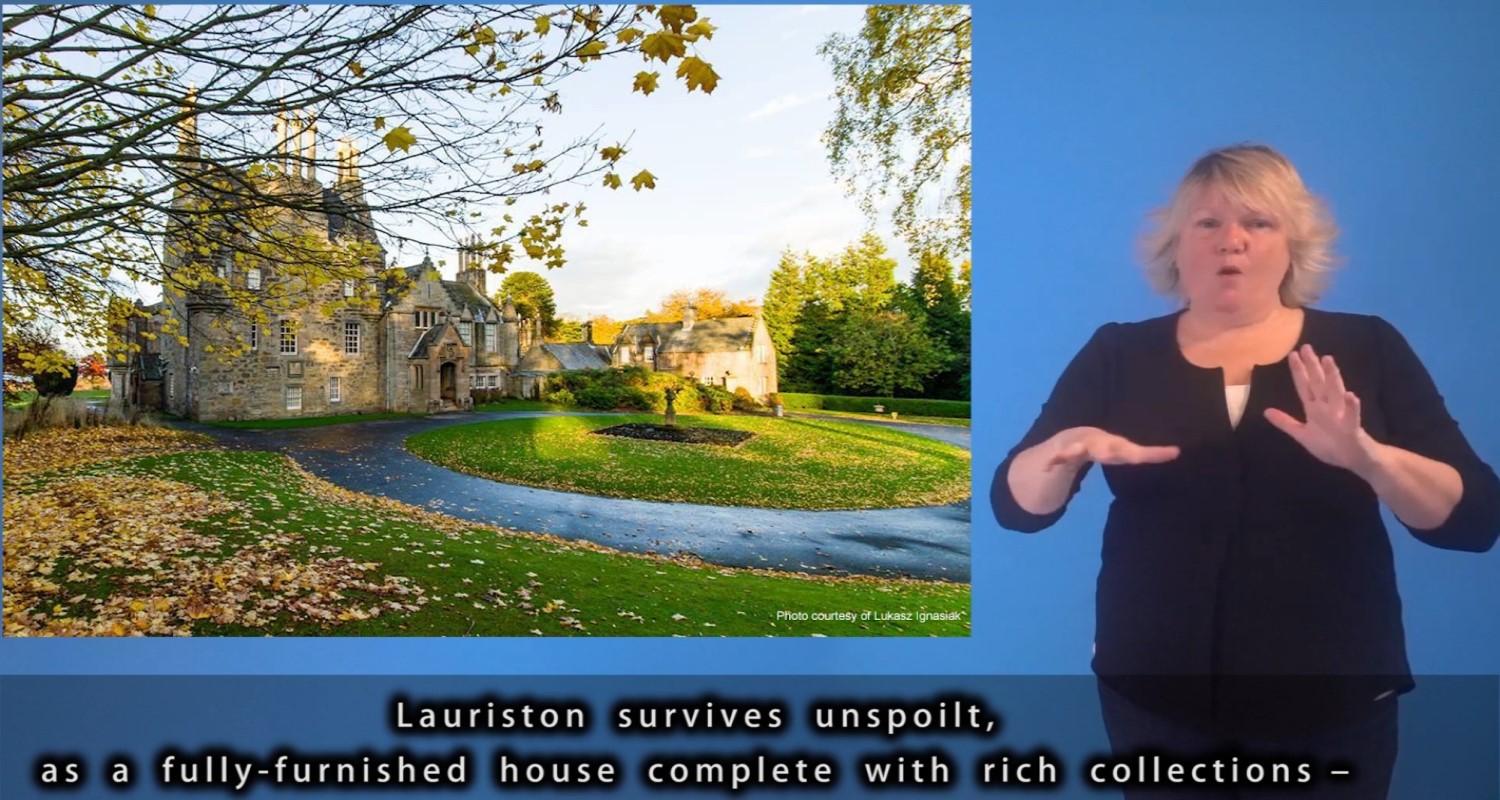 An image of a BSL interpreter beside a photo of Lauriston Castle. Subtitles are at the foot of the image