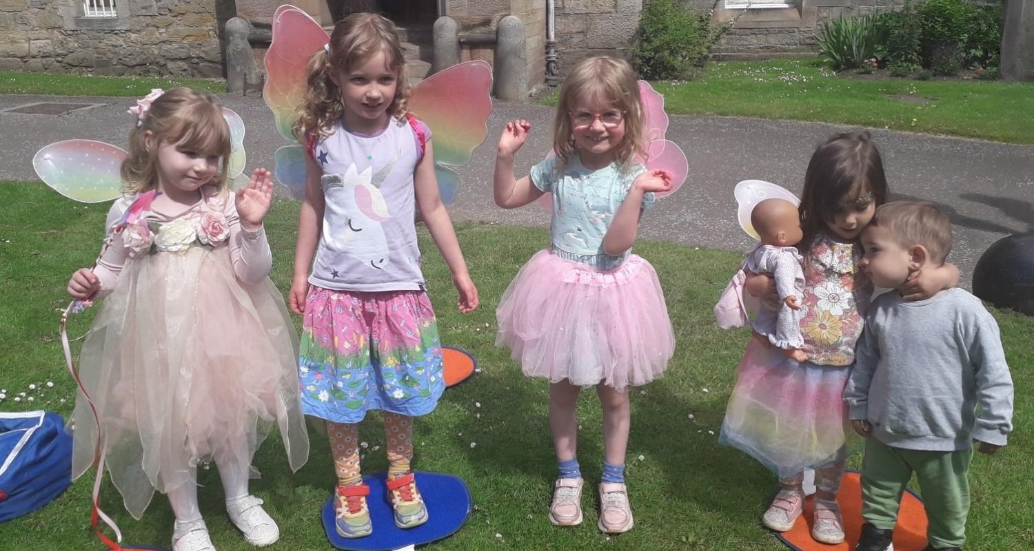 A group of children dressed up as fairies standing outside Lauriston Castle