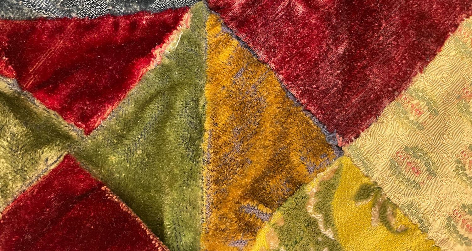 Detail of patchwork quilt with colourful triangular sections