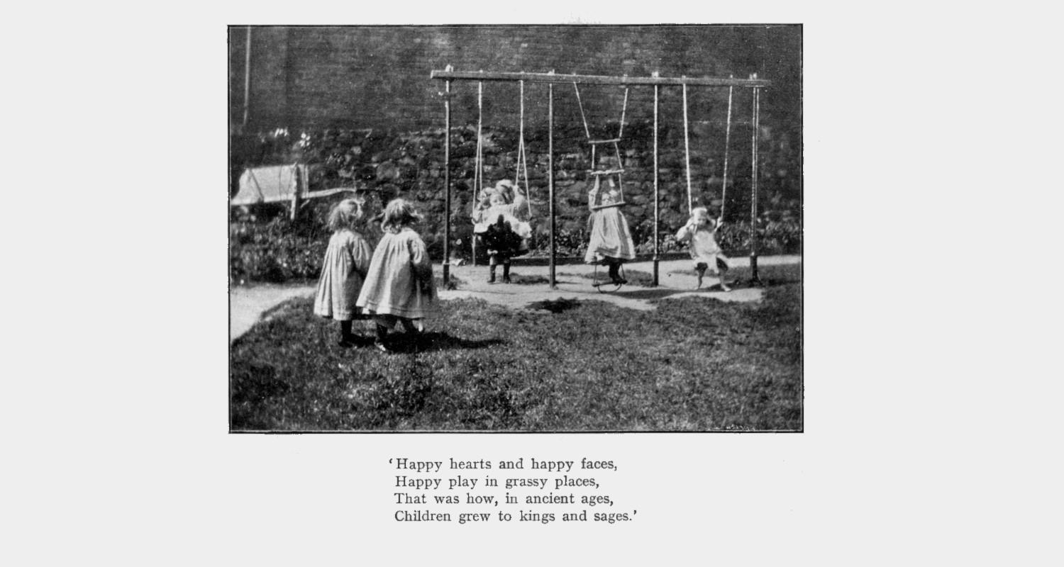 A black and white photo of three little girls perhaps in Edwardian times, playing on swings as two more look on