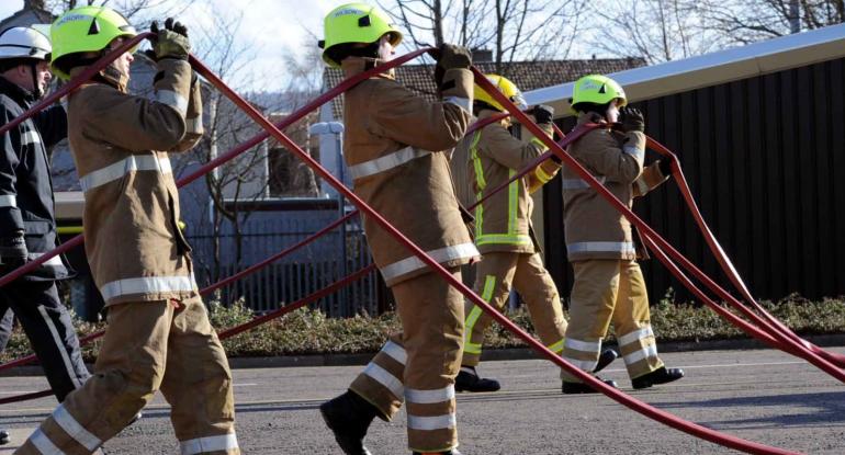 Firefighters in Gullane participating in hose running drills