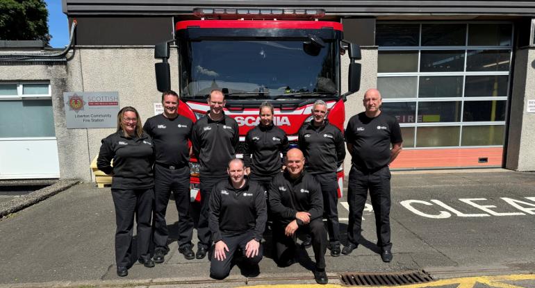 Fire crew at Liberton Fire Station standing in front of a fire engine