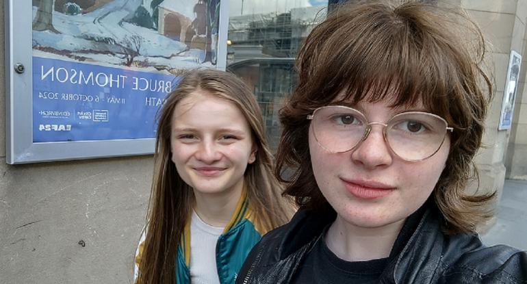 Two young people take a selfie outside the City Art Centre building