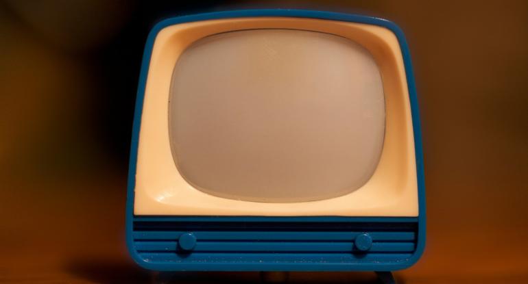 A photograph of a blue and cream toy TV