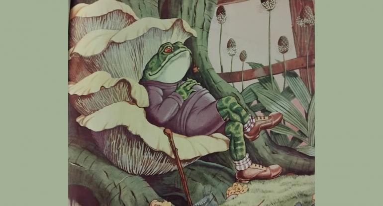 A drawing of a toad, in a purple jumper and shorts, wearing brogues, reclining on a leaf