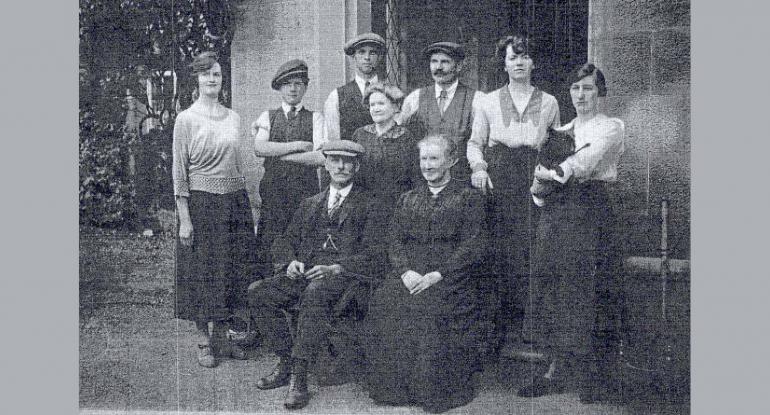 A black and white image showing staff of Lauriston Castle from Edwardian times. Two are seated, seven standing, one holding a black cat