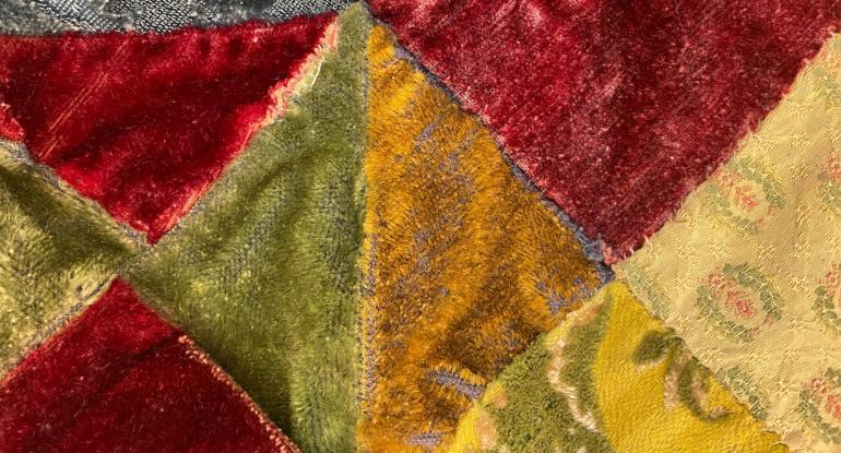 Detail of patchwork quilt with colourful triangular sections