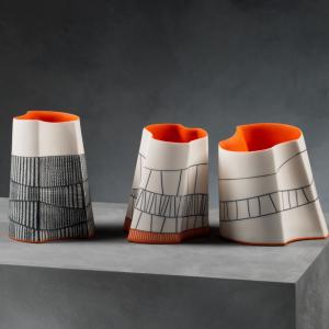 Three uniquely designed vases displayed together, showcasing a variety of artistic styles and colors